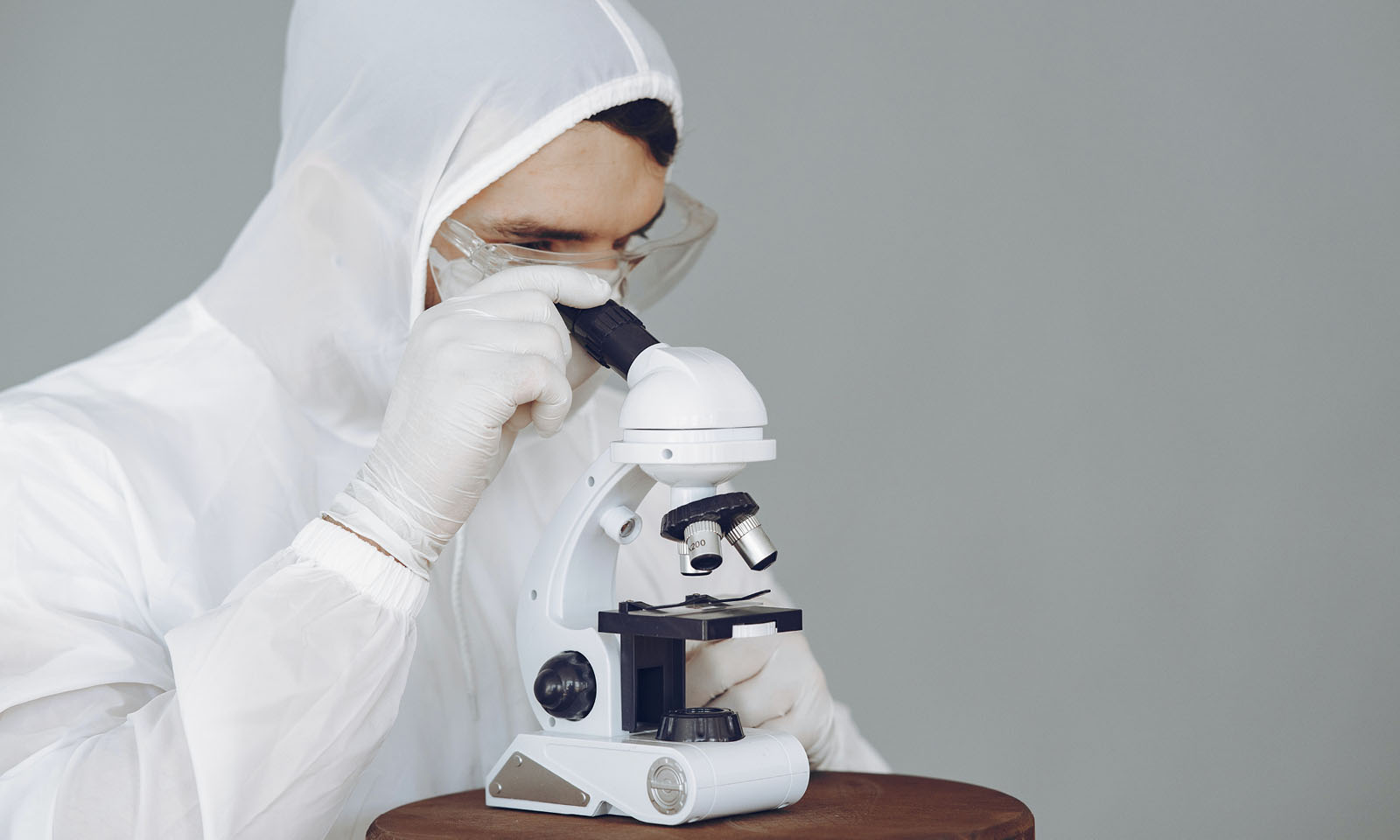 Scientist looks into a microscope